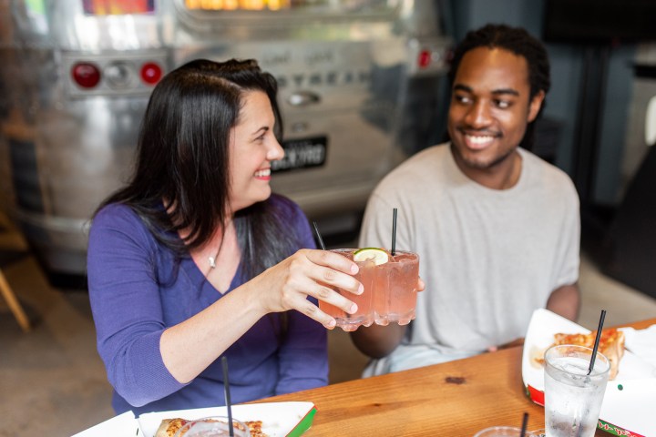 a woman sitting at a table eating food