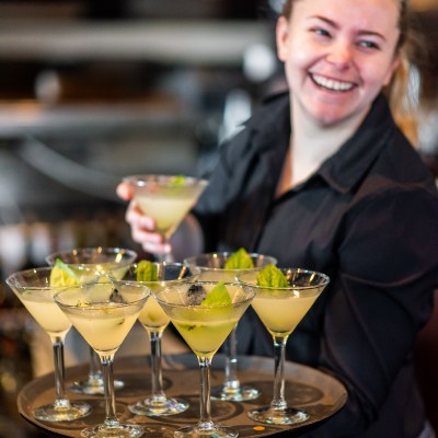 Anna Nemtsova sitting at a table with wine glasses