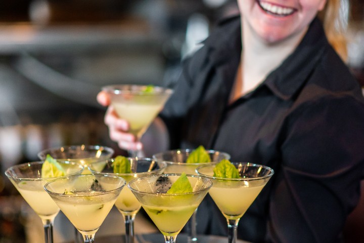 Anna Nemtsova sitting at a table with wine glasses