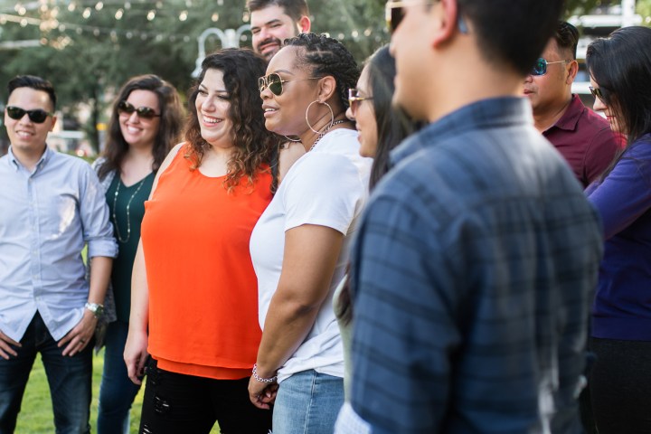 a group of people standing in front of a crowd posing for the camera