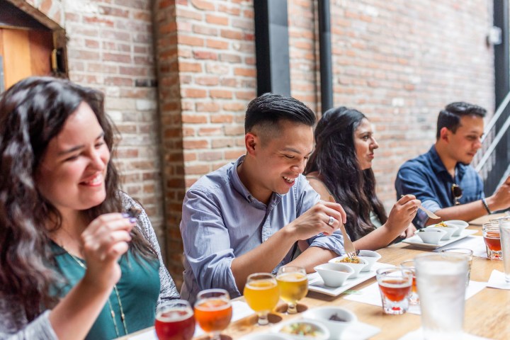 a group of people sitting at a table eating food