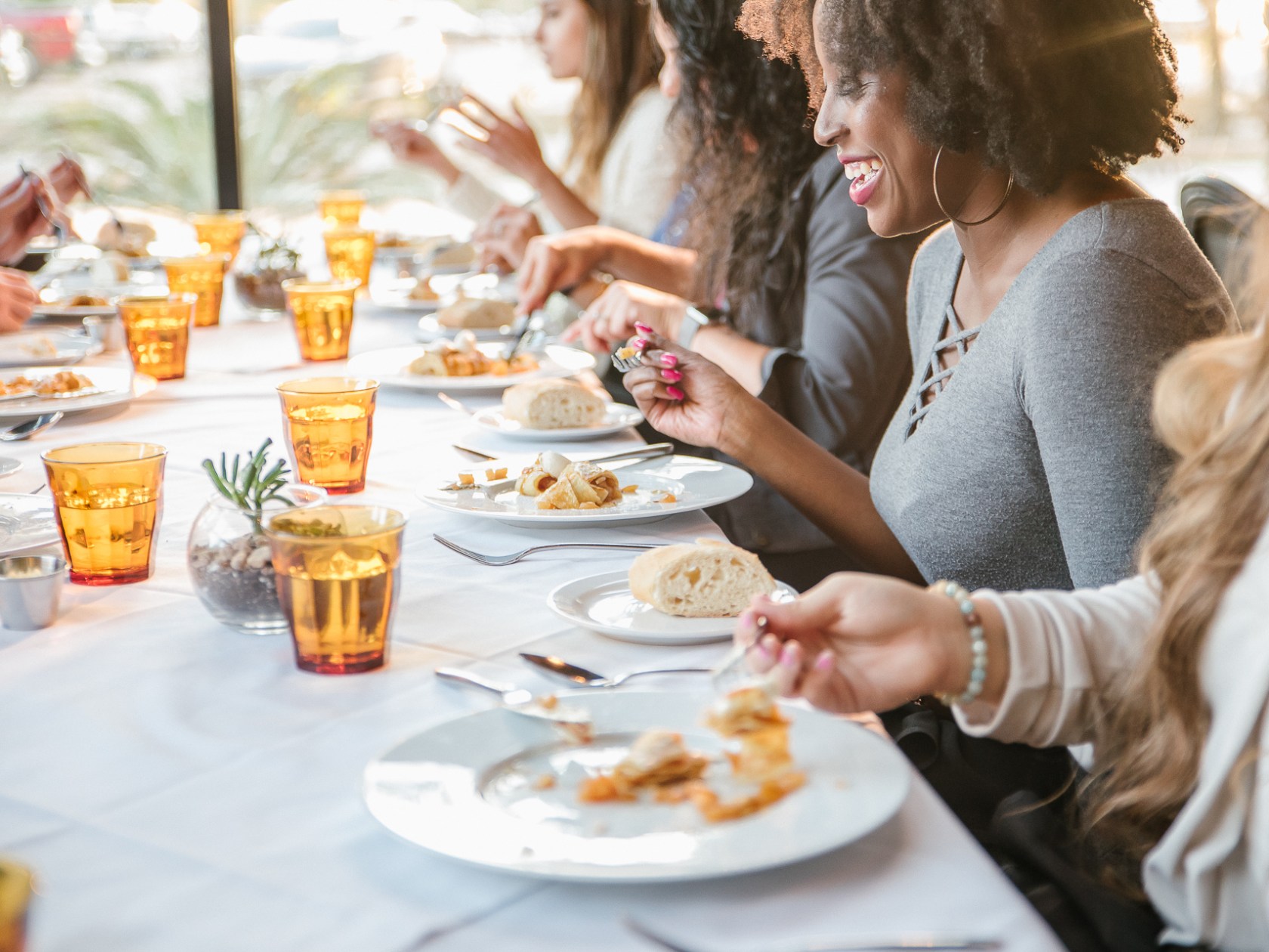 a woman sitting at a table eating pizza