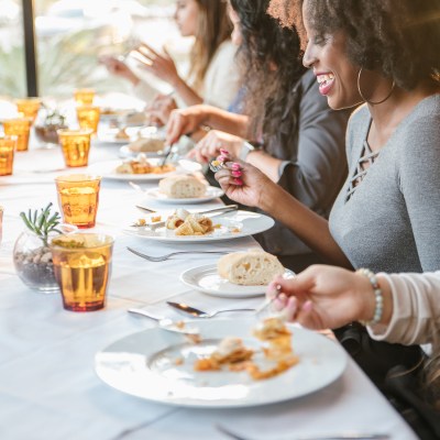 a woman sitting at a table eating pizza